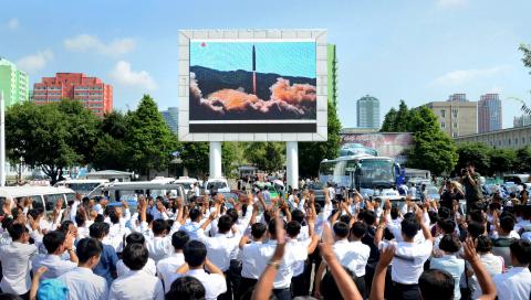 People watch a huge screen showing the test launch of intercontinental ballistic missile Hwasong-14 in this undated photo released by North Korea's Korean Central News Agency (KCNA), July 5, 2017. PHOTO BY REUTERS/KCNA