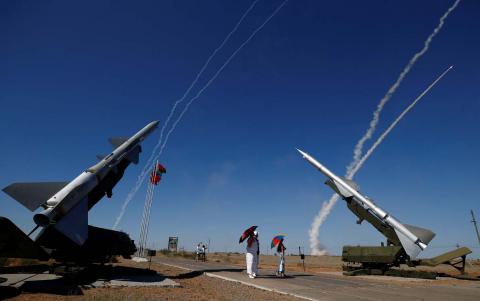 People watch S-300 air defense missile systems launching missiles during the Keys to the Sky competition at the International Army Games 2017 at the Ashuluk shooting range outside Astrakhan, Russia, August 5, 2017. PHOTO BY REUTERS/Maxim Shemetov