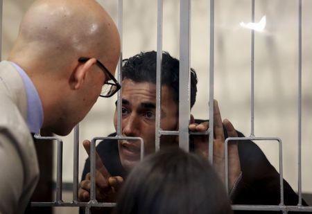 Mohammed Ali Malek (R) speaks with his lawyer Massimo Ferrante at Catania's tribunal, April 24, 2015. PHOTO BY REUTERS/Antonio Parrinello