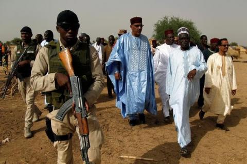 Niger's Interior Minister Mohamed Bazoum (C) walks during a visit in a camp of the city of Diffa following attacks by Boko Haram fighters in the region of Diffa, Niger, June 18, 2016. PHOTO BY REUTERS/Luc Gnago