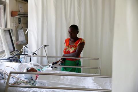 Lenzer, mother of six month-old Samantha Pendo, stands next to her bed as the girl remains in critical condition in the Intensive Care Unit of Aga Khan Hospital in Kisumu, Kenya, August 14, 2017. PHOTO BY REUTERS/Baz Ratner