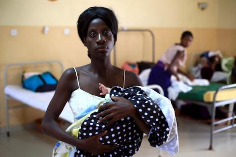 A mother holds her baby after breastfeeding at Kisenyi health centre in Uganda's capital Kampala April 10, 2015. PHOTO BY REUTERS/James Akena