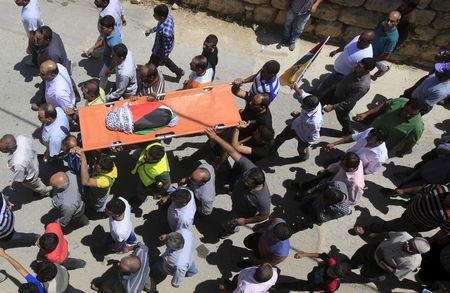 Mourners carry the body of 18-month-old Palestinian baby Ali Dawabsheh, who was killed after his family's house was set to fire in a suspected attack by Jewish extremists in Duma village near the West Bank city of Nablus, July 31, 2015. PHOTO BY REUTERS/Abed Omar Qusini