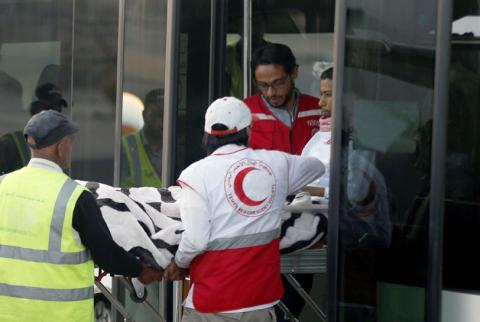 Yemeni Red Crescent staffers carry Saudi prisoner Moussa Awaji from a bus to board an ICRC plane at the Sanaa airport after he was released by the Houthis in Sanaa, Yemen, January 29, 2019. PHOTO BY REUTERS/Khaled Abdullah