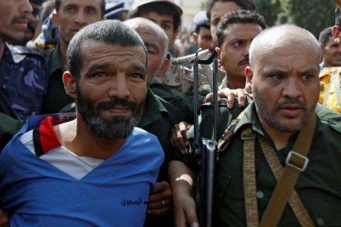 Police officers escort Muhammad al-Maghrabi, 41, who was convicted of raping and murdering a three-year-old girl, to the execution site, in Sanaa, Yemen, July 31, 2017. PHOTO BY REUTERS/Khaled Abdullah