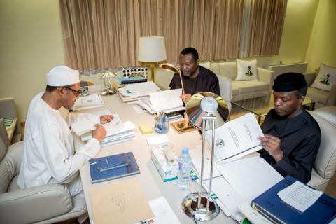 President Muhammadu Buhari, Vice President Yemi Osinbajo and Minister of Budget and National Planning Senator Udoma Udo Udoma read copies of the details of the submitted 2016 national budget by the National Assembly in Abuja, Nigeria, April 10, 2016. PHOTO BY REUTERS/Stringer