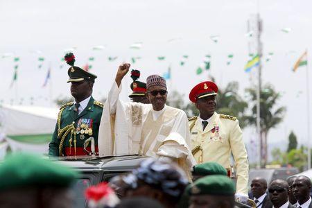 Nigeria's new President Muhammadu Buhari rides on the motorcade while inspecting the guard of honour at Eagle Square in Abuja, Nigeria, May 29, 2015. PHOTO BY REUTERS/Afolabi Sotunde