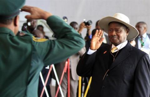 Uganda's President Yoweri Museveni (R) receives a salute as he arrives for the extraordinary session of the African Union's Assembly of Heads of State and Government on the case of African Relationship with the International Criminal Court