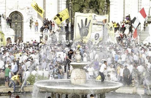 Muslim Brotherhood supporters gather in front of Qubba Palace in Cairo