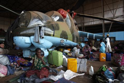 Muslims sit at a camp for displaced people at Mpoko international airport in Bangui, as they wait to leave the capital