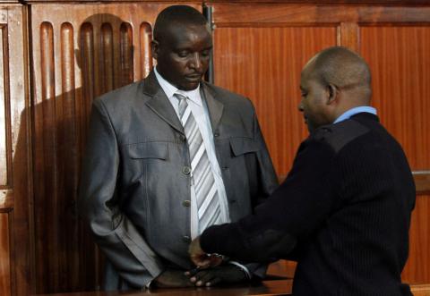 Nahashon Mutua, a former senior Kenyan police officer, is handcuffed in the dock at his trial in Nairobi, December 13, 2018. PHOTO BY REUTERS/Njeri Mwangi