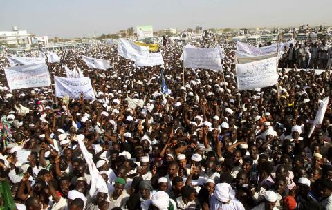 National Congress Party (NCP) supporters wave as Sudanese President and NCP presidential candidate Omar Hassan al-Bashir addresses the crowed during his campaign ahead of the 2015 presidential elections in Madani, the capital of Jazeera State, February 26, 2015. PHOTO BY REUTERS/ Stringer