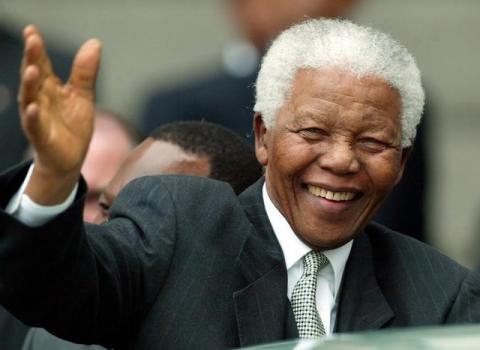 Former South African presidents Nelson Mandela waves to the crowds as he arrives to address the country's Parliament in Cape Town, May 10, 2004. PHOTO BY REUTERS/Mike Hutchings