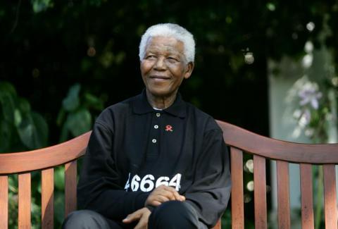 Nelson Mandela smiles as he watches the coronation ceremony of Bafokeng's King Leruo Tshekedi Molotlegi at a sports stadium in Phokeng, 120 km (81 miles) north of Johannesburg