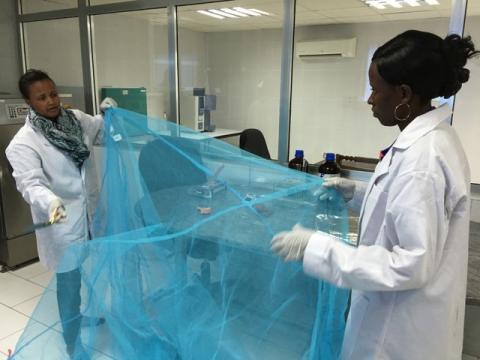 Workers look for holes in mosquito netting at the A to Z Textile Mills factory producing insecticide-treated bednets in Arusha, Tanzania, May 10, 2016. PHOTO BY REUTERS/Katy Migiro