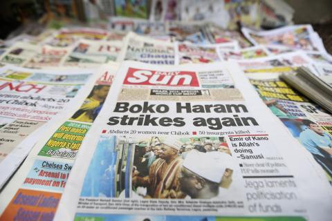 A newspaper with its frontpage headline on an abduction of women from a village in northeast Nigeria, is displayed at a vendor's stand along a road in Ikoyi district in Lagos