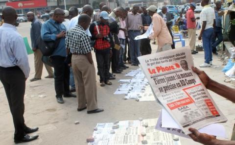 Residents read newspapers with reports of Yellow Fever, along the streets in Kinshasa, capital of the Democratic Republic of the Congo, June 21, 2016. PHOTO BY REUTERS/Jean Robert N'kengo