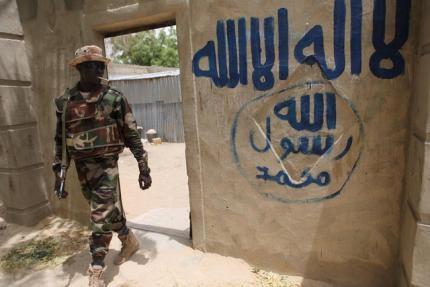 A Nigerien soldier walks out of a house that residents say a Boko Haram militant had forcefully seized and occupied in Damasak, March 24, 2015. PHOTO BY REUTERS/Joe Penney