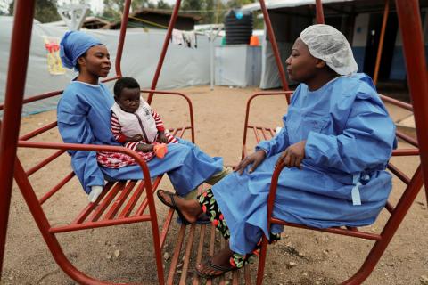 Noella Kavira Kitakya, 26, holding 16-month-old Kambale Eloge, whose mother died of Ebola, talks to Arlette Kavugho, 40, mother of six, in the courtyard of United Nations Children's Fund (UNICEF) creche for children whose families are suspected or confirmed Ebola cases, next to an Ebola treatment centre (ETC) in Katwa, near Butembo, in the Democratic Republic of Congo, October 2, 2019. PHOTO BY REUTERS/Zohra Bensemra