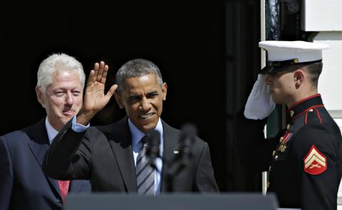 United States President Barack Obama (C) is joined by former U.S. President Bill Clinton (L) for a AmeriCorps Pledge ceremony on the South Lawn of the White House in Washington