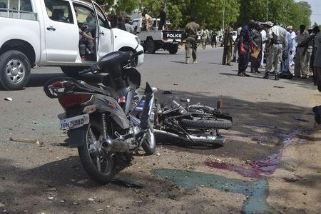 Security officers stand at the site of a suicide bombing in Ndjamena, Chad, June 15, 2015. PHOTO BY REUTERS/Moumine Ngarmbassa