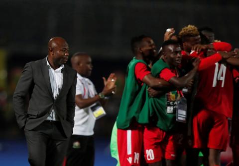 Kenya's Michael Olunga celebrates scoring their third goal with team mates as Tanzania coach Emmanuel Amunike reacts. PHOTO BY REUTERS/Amr Abdallah Dalsh