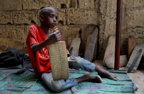 Omar Wone, 8, from Futa, a Koran student, called a talibe, sits on the floor of the daara (Koranic school) where he lives and learns Koran in Saint-Louis, Senegal, February 8, 2019. Omar was complaining about chest pain. PHOTO BY REUTERS/Zohra Bensemra