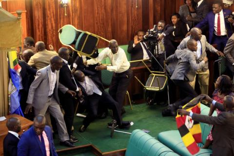 Ugandan opposition lawmakers fight with plain-clothes security personnel in the parliament while protesting a proposed age limit amendment bill debate to change the constitution for the extension of the president's rule, in Kampala, Uganda, September 27, 2017. PHOTO BY REUTERS/James Akena