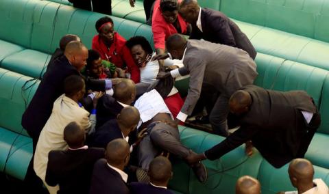 Ugandan opposition lawmakers fight with plain-clothes security personnel in the parliament while protesting a proposed age limit amendment bill debate to change the constitution for the extension of the president's rule, in Kampala, Uganda, September 27, 2017. PHOTO BY REUTERS/James Akena