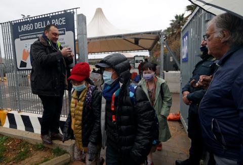 Passengers wearing face masks are seen on a terminal after disembarking from the Costa Smeralda cruise ship, after tests on a woman from Macau with suspected coronavirus came back negative, in Civitavecchia, Italy, January 31, 2020. PHOTO BY REUTERS/Yara Nardi