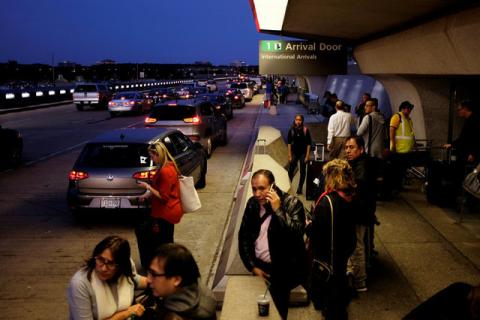 International passengers wait for their rides outside the international arrivals exit at Washington Dulles International Airport in Dulles, Virginia, U.S., September 24, 2017. PHOTO BY REUTERS/James Lawler Duggan