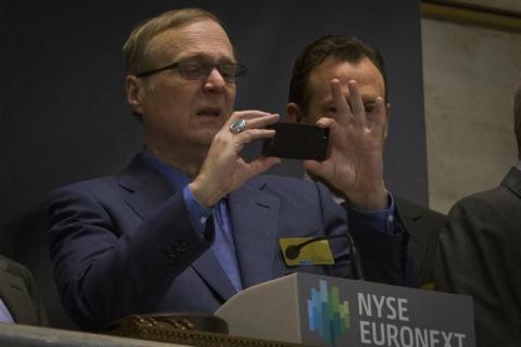 Paul Allen takes a photo prior to ringing the opening bell at the New York Stock Exchange