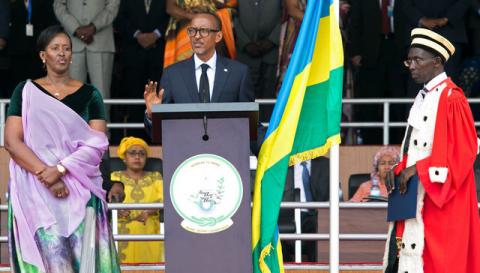 Rwanda's President-elect Paul Kagame (C) takes the oath of office as his wife Jeannette and Rwanda's Chief Justice Sam Rugege (R) look on during his swearing-in ceremony at Amahoro stadium in Kigali, Rwanda, August 18, 2017. PHOTO BY REUTERS/Jean Bizimana