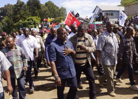 Democratic Republic of Congo's President Joseph Kabila (front C) walks along a street in Bunagana, a town formerly held by M23 rebels in eastern Democratic Republic of the Congo