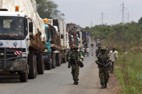 African Union (AU) peacekeepers guard a commercial convoy making its way to the border of Cameroon, near Bangui