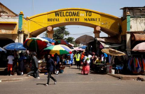 People walk along the gate of Royal Albert Market in Banjul, Gambia, January 23, 2017. PHOTO BY REUTERS/Afolabi Sotunde