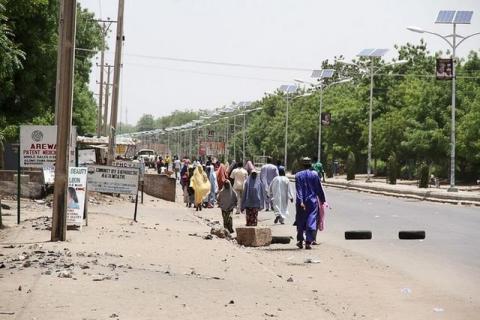 People walk along a road as they flee, in Maiduguri in Borno State, Nigeria, May 14, 2015. PHOTO BY REUTERS/Stringer