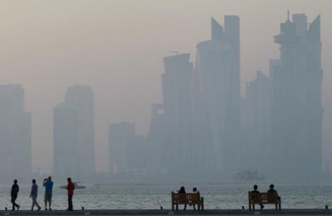 People sit on the corniche in Doha, Qatar, June 15, 2017. PHOTO BY REUTERS/Naseem Zeitoon