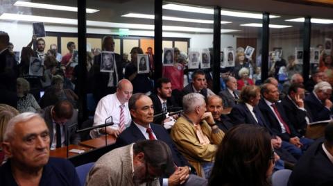 People hold up portraits of those who disappeared during Argentina's military dictatorship, behind former Navy officers on trial for their role during the 1976-1983 dictatorship, in Buenos Aires, November 29, 2017. PHOTO BY REUTERS/Marcos Brindicci