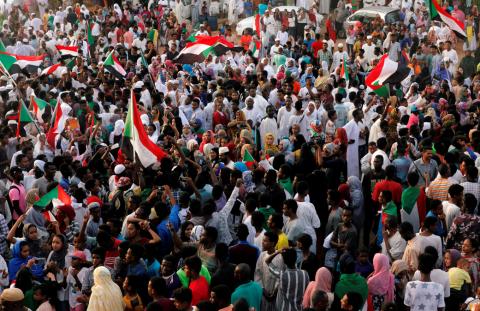 Sudanese people chant slogans and wave their national flags as they celebrate, after Sudan's ruling military council and a coalition of opposition and protest groups reached an agreement to share power during a transition period leading to elections, along the streets of Khartoum, Sudan, July 5, 2019. PHOTO BY REUTERS/Mohamed Nureldin Abdallah