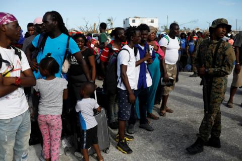 A soldier controls the crowd at Marsh Harbour Government Port during an evacuation operation after Hurricane Dorian hit the Abaco Islands in Marsh Harbour, Bahamas, September 6, 2019. PHOTO BY REUTERS/Marco Bello