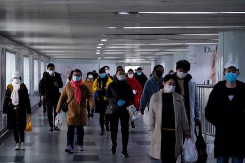 People wearing face masks are seen in an underpass leading to a subway station in the morning after the extended Lunar New Year holiday caused by the novel coronavirus outbreak, in Shanghai, China, February 10, 2020. PHOTO BY REUTERS/Aly Song