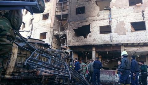 Residents and soldiers loyal to Syria's President Bashar al-Assad inspect damage after a suicide attack in Sayeda Zeinab, a district of southern Damascus, Syria January 31, 2016. PHOTO BY REUTERS/Stringer