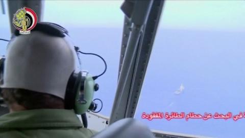 A pilot looks out of the cockpit during a search operation by Egyptian air and navy forces for the EgyptAir plane that disappeared in the Mediterranean Sea, in this still image taken from video May 20, 2016. PHOTO BY REUTERS/Egyptian Military