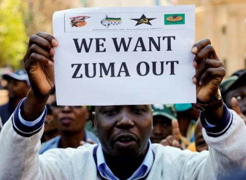 A member of a group planning to stage an ‘Occupy’ protest outside the ANC headquarters demanding South African President Jacob Zuma and other senior party officials to resign, holds a placard in downtown Johannesburg, South Africa, September 5, 2016. PHOTO BY REUTERS/Siphiwe Sibeko