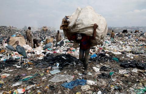 A scavenger carries recyclable plastic materials packed in a sack at the Dandora dumping site on the outskirts of Nairobi, Kenya, August 25, 2017. PHOTO BY REUTERS/Thomas Mukoya