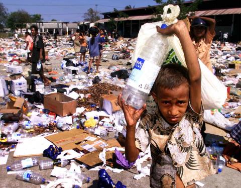 East Timorese collect plastic containers and leftovers at a garbage dump in Dili September 27. Indonesia's armed forces handed military control of East Timor to U.N. troops on Monday, formally marking Indonesia's first big step out of the territory it has ruled for almost 24 years. PHOTO BY REUTERS