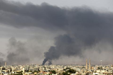 Black plumes of smoke is seen in the vicinity of Camp Thunderbolt, after clashes between militants, former rebel fighters and government forces in Benghazi