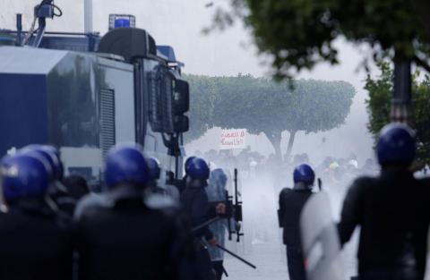 Police use tear gas to disperse crowds as people march to protest against President Abdelaziz Bouteflika's plan to seek a fifth term. PHOTO BY REUTERS/Ramzi Boudina