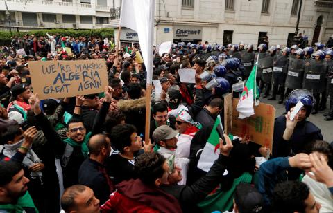 Police members stand guard as people protest against President Abdelaziz Bouteflika, in Algiers, Algeria, March 8, 2019. PHOTO BY REUTERS/Zohra Bensemra